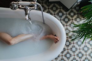 person-in-white-ceramic-bathtub
