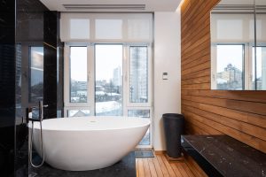 a modern bathroom interior with a wooden pattern and panoramic window