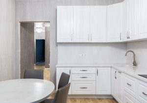 a modern kitchen interior with replaced cabinets and drawer handles