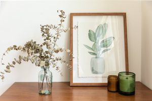  Famed plant painting over a wooden table 