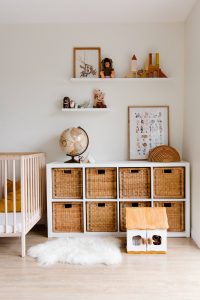 interior of a kid's room with wooden furniture and faux fur rug