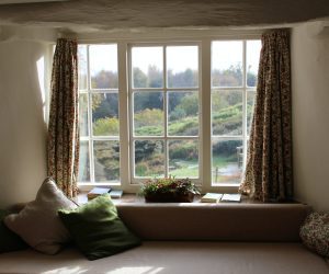 a wide open window with curtains