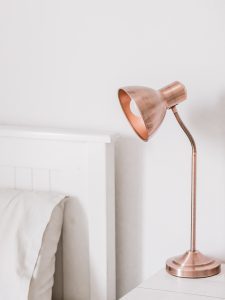 a copper table lamp on a table